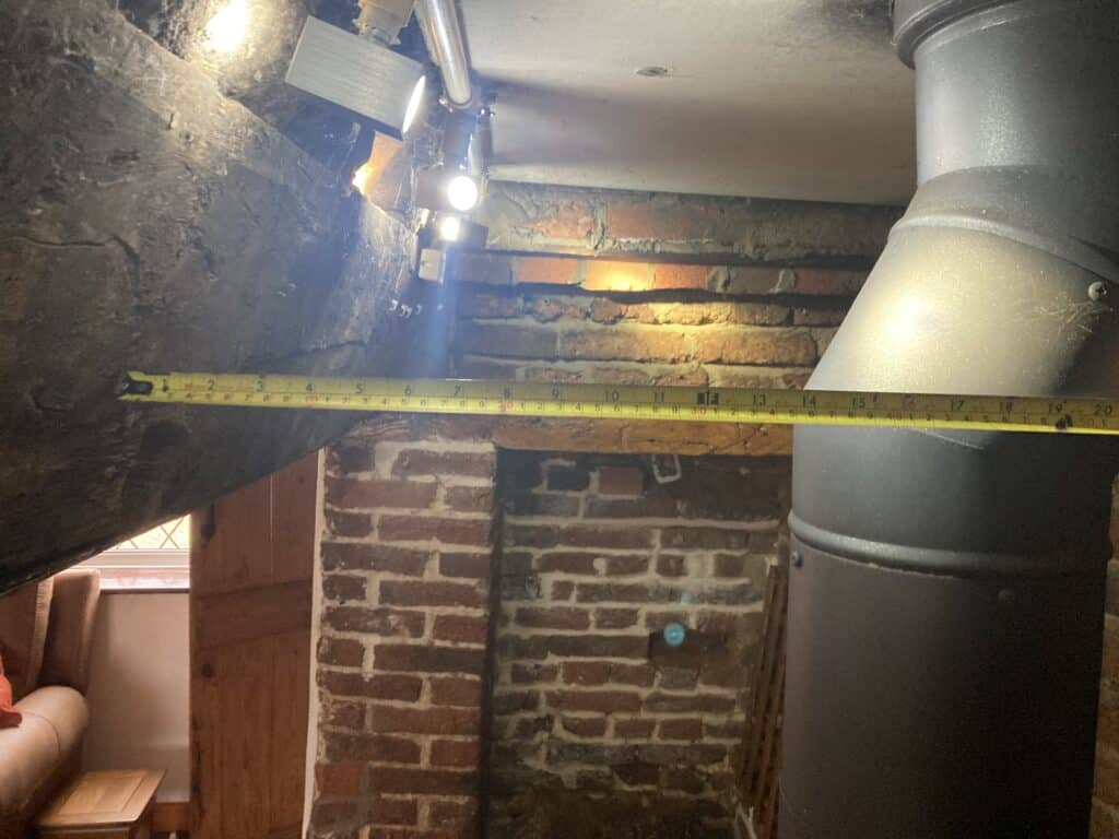 Connecting flue pipe too close to unprotected timber beam