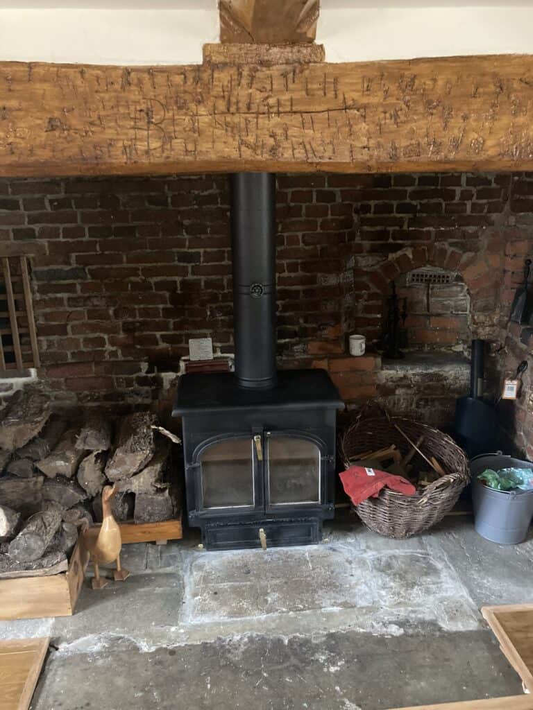 multi fuel appliance positioned in inglenook fireplace